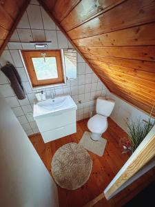 a bathroom with a toilet and a sink and a window at Paloznak Panoráma in Paloznak +66 photos
