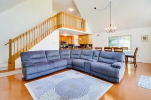 a living room with a blue couch and a table at Stunning Pocono Lake Vacation Rental with Huge Deck! in Pocono Lake