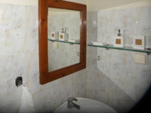 a bathroom with a sink and a mirror at 56s.m comftorable studio,airport area in Anemómylos