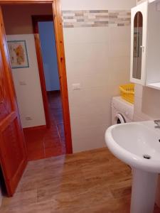 a bathroom with a sink and a washing machine at Luna e Mare in Cala Gonone