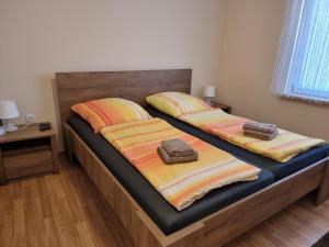two beds with towels on top of them in a bedroom at Apartments Lean in Poreč +40 photos