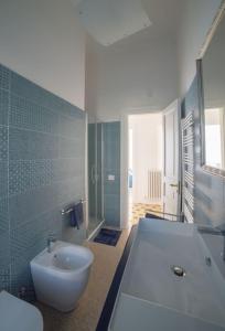 a bathroom with a white tub and a sink at AM Apartment in Cosenza