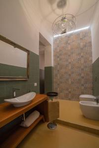 a bathroom with a sink and a toilet and a mirror at AM Apartment in Cosenza