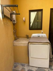 a small bathroom with a stove and a sink at Casa Mi Pueblito in Ajijic +47 photos
