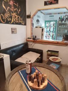 a room with a table with a can of beer at Hostel La Casa de Tounens in Puerto Madryn