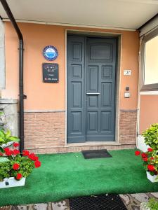 a gray door on a house with a green lawn at Siclari B&B-Rooms&Suite in Taurianova