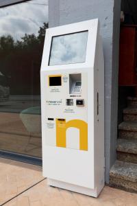 a white and yellow gas pump on the side of a building at Mendi Azpi Rooms in Mutriku