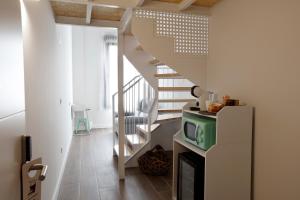 a kitchen with a staircase and a refrigerator at Mendi Azpi Rooms in Mutriku