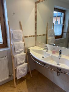 a bathroom with a sink and a mirror at Scharler's Hotel in Uttendorf