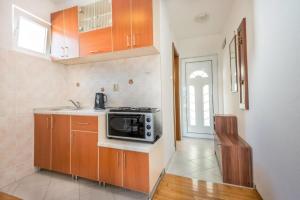 cocina con fregadero y microondas en Majka Apartments en Kotor