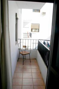 a balcony with a chair sitting on top of a building at Apartamento de 3 habitaciones in Valencia