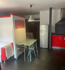 a small kitchen with a table and a refrigerator at Zoe in Vilamós