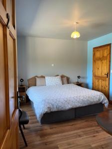 a bedroom with a large bed and a wooden floor at Douglasha House V93RX64 in Killarney