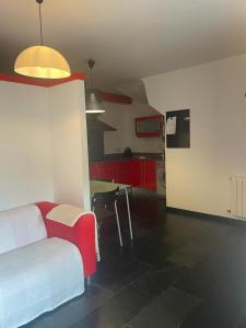 a bedroom with a bed and a kitchen with red cabinets at Zoe in Vilamós