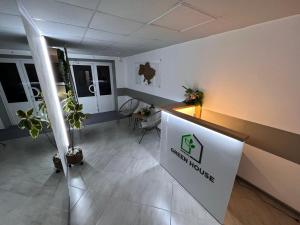 an empty office with a reception desk and plants at Хостел Житомир GREEN HOUSE in Zhytomyr