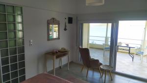 a room with a table and chairs and a mirror at Odyssia near the Seaside in Aghios Petros Alonissos