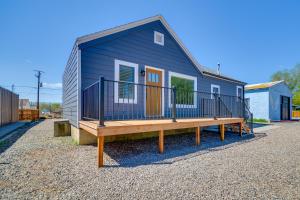 a blue tiny house with a large deck at Thermopolis Vacation Rental Walk to Bighorn River in Thermopolis