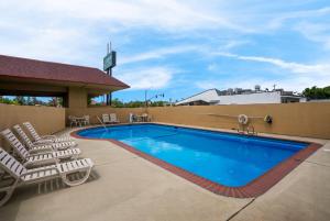 a pool at a hotel with lounge chairs at Quality Inn Fairfield Napa Valley Area in Fairfield