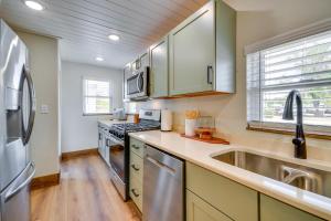 a kitchen with stainless steel appliances and a sink at Thermopolis Vacation Rental Walk to Bighorn River in Thermopolis