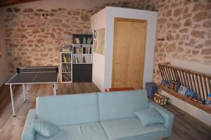 a living room with a blue couch and a table at Lo Molí de Bot in Bot