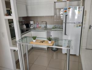 a kitchen with a glass table and a refrigerator at Zencity in Buenos Aires