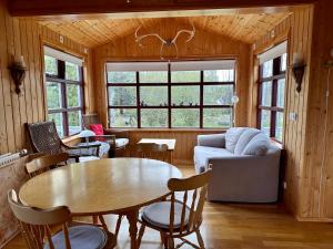 a living room with a table and a couch at Red Riding Hood Cabin On the Golden Circle Next to Kerið in Selfoss