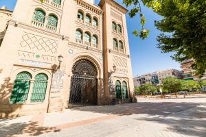 a large building with a large gate in a city at Modern Plaza de Toros Apartment with Free Parking in Granada