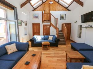 a living room with a blue couch and a table at Y Felin in Haverfordwest