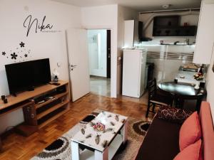 a living room with a couch and a table at Apartman Nika in Kragujevac