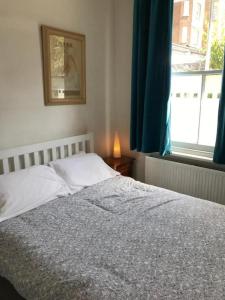 a bedroom with a bed and a window at Trendy 2BD flat in West Hampstead in London