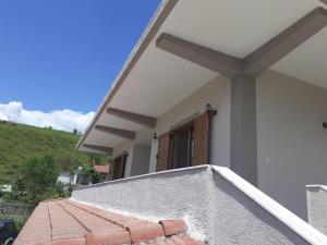 a balcony of a house with a window at Kanushi house in Gjirokastër