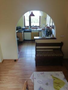 a kitchen with an archway in the middle of a room at Villa meisterburg in Ściegny