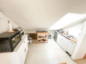 a kitchen with white cabinets and a stove top oven at Mandre Island Pag in Mandre