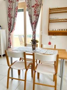 a dining room with a table and two chairs at Mandre Island Pag in Mandre +4 photos