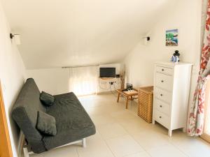 a living room with a couch and a dresser at Mandre Island Pag in Mandre