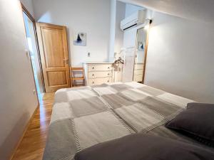 a bedroom with a large bed and a dresser at Mandre Island Pag in Mandre