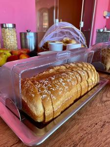 a loaf of bread in a plastic container on a table at Pousada Paraíso dos Corais in Arraial do Cabo