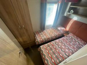 a small room with a bench and a window at Silver Birch Lodge in Auchterarder