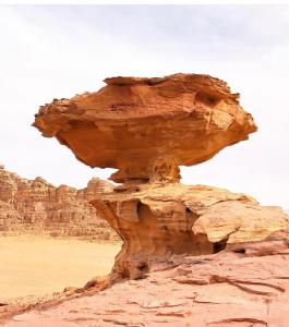 a rock formation in the desert at Wadi Rum Red Sand Camp in Wadi Rum