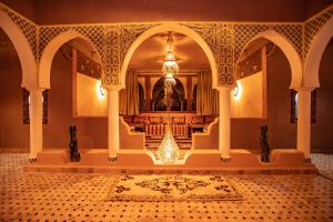 a room with a fountain in the middle of a building at Riad Merzouga Dunes in Merzouga