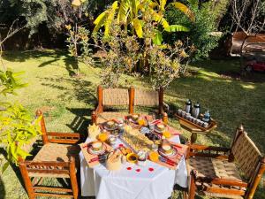 a table with plates of food on it in a yard at Ilafe Farmhouse, Villa avec Piscine Chauffée Privée et Jacuzzi pour Familles in Marrakech