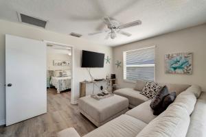 a living room with a couch and a ceiling fan at Ocean View in Holmes Beach