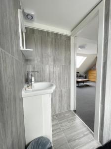 a bathroom with a white sink in a room at Cosy Bright Studio Apartment Close to Wembley Stadium in London +50 photos