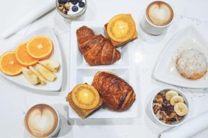 a white table topped with plates of pastries and coffee at City Mills Hotel in Columbus
