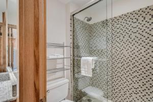 a bathroom with a toilet and a glass shower at Laurelwood Condominiums 105 in Snowmass Village +15 photos