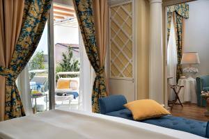 a bedroom with a bed and a view of a patio at Palace Hotel in Viareggio