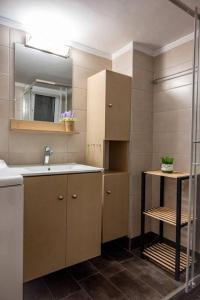 een badkamer met een wastafel en een spiegel bij The Athenian Hideaway 2- Bedroom apartment in Thiseio in Athene