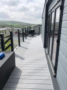 a wooden walkway on the side of a building at Unique 4/6 berth 2 bed tribeca with great views in Bembridge