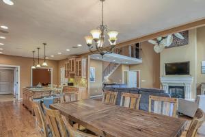 a dining room and kitchen with a wooden table and chairs at Paradise at Sunset Cove in Moneta