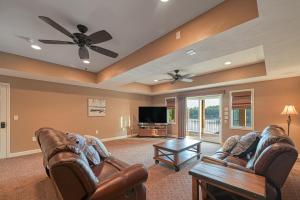 a living room with leather furniture and a flat screen tv at Paradise at Sunset Cove in Moneta